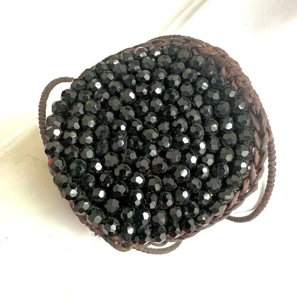 Round  black beaded bracelet on brown cord
